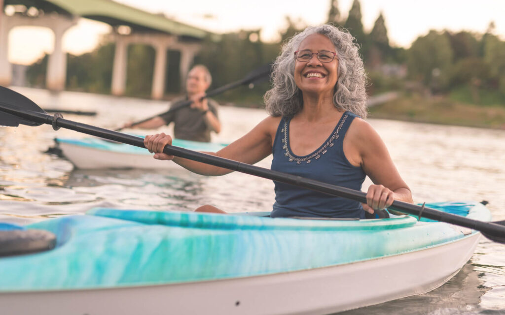 Senior woman kayaking in a river